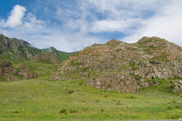 Mountain landscape against a bright blue sky.