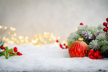Christmas Holiday background with snow, fir tree and decorations with christmas light behind....