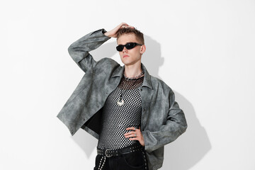 Fototapeta premium Handsome young man wearing stylish jacket and sunglasses on white background