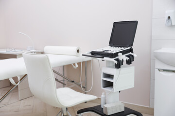Modern ultrasound machine and examination bed in clinic
