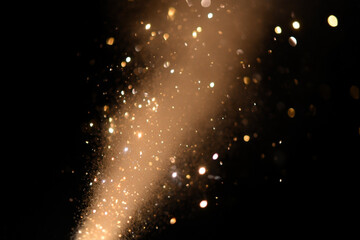 Golden Sparkling Glitter Against Dark Background for Festive Celebrations and Luxury Designs adding...