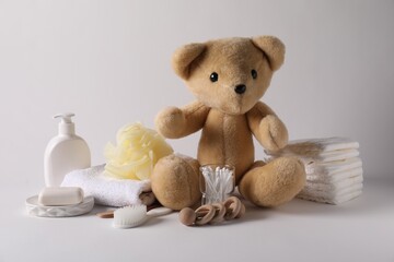 Baby accessories and body care products on light grey background