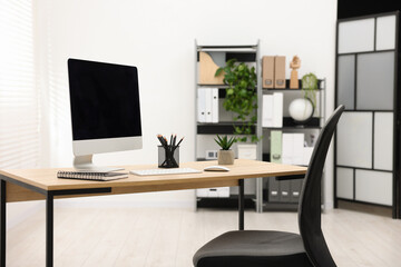 Stylish workplace with modern computer and stationery on wooden table in office