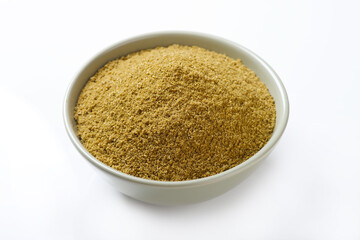 Indian food spice called coriander powder isolated on white background 