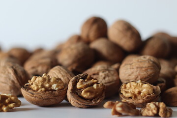 Walnuts in shell and cracked with exposed kernels. Winter diet, theme of nutrition, tradition
