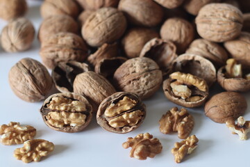 Walnuts in shell and cracked with exposed kernels. Winter diet, theme of nutrition, tradition