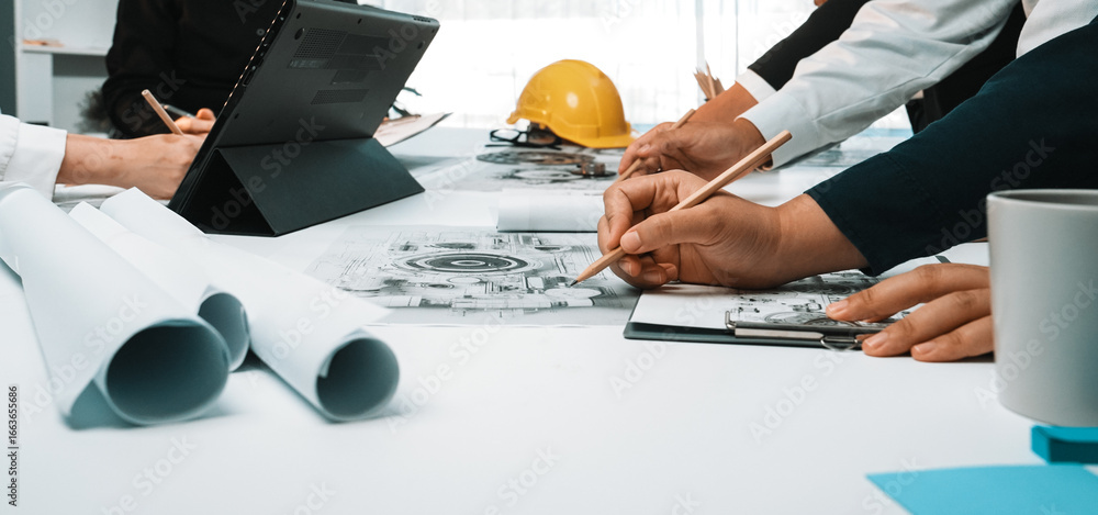 Poster a dynamic design meeting in a modern office where engineers and architects collaborate on blueprints