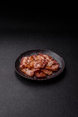 Cooked crispy fried pork bacon strips for a hearty breakfast. Fried bacon strips