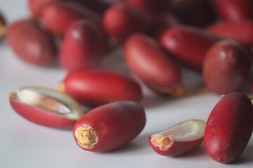 Red dates or jujubes close-up, whole & sliced with white flesh. Winter fruit, wellness and sweetness
