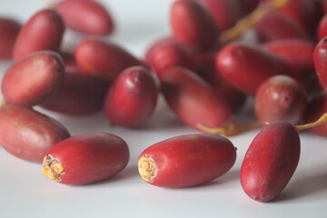 Red dates or jujubes close-up, whole & sliced with white flesh. Winter fruit, wellness and sweetness