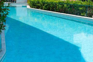 Empty swimming pool with table and chairs in summer,sofa resort neary sea and beach,restaurant and lunch,rest vacation concept.