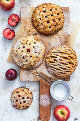 Assorted homemade rustic american style apple and plum pies