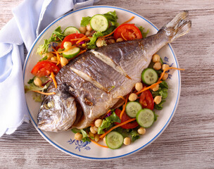 Baked whole gilthead bream fish with chickpea salad