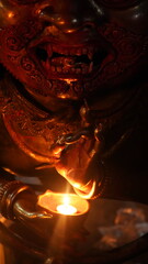Bhairab Idol Holding a Lit Oil Lamp during Evening Ritual