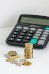 Stacked Coins with Calculator and Wallet