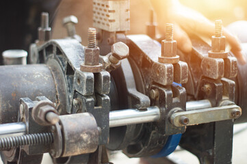 Plumbers use tools to connect large water pipes.