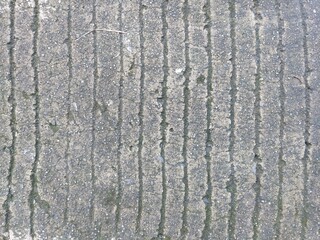 Fototapeta premium close up of rough concrete surface with engraved vertical striped texture