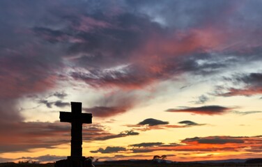 Stone Block Cross on Fence Post Sunrise Clouds of Red Silhouette