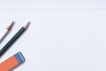 Pencils and eraser on blank Graph paper sheet background. Copy space. Template Mock up