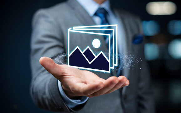 Digital asset management and stock photo library concept with businessman holding virtual picture icons.