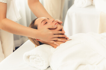 Caucasian woman enjoying relaxing anti-stress head massage and pampering facial beauty skin...