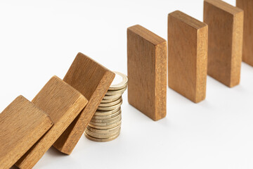 Pile of coins Stopping Falling wooden Dominoes effect. Money support or stimulus stop the financial crisis domino effect