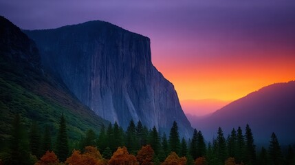 A mountain range with a large cliff and a beautiful sunset in the background
