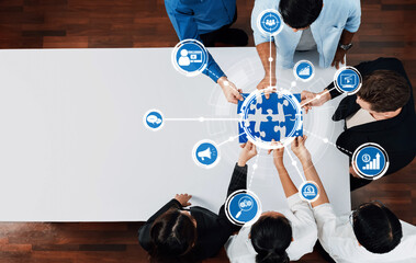 A diverse team collaborates around a globe, engaging with digital icons that symbolize marketing strategies, analytics, and business growth in a modern workspace. Amity