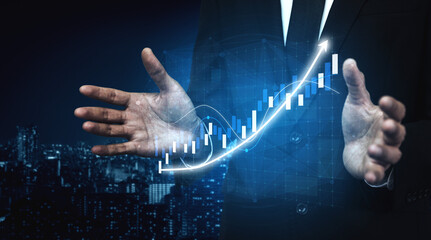 A businessman gestures with open hands, presenting a growth concept with an illuminated graph overlay against a city skyline. This image symbolizes success and innovation. Impute