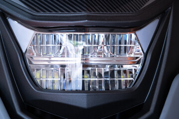 Closeup headlights modern motorcycle. Motorcycle part.