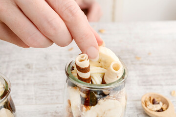 How to make layer dessert with muesli, chocolate and banana fruits.