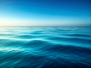 Blue sea and sky landscape with waves clouds and sunlight over calm ocean horizon   