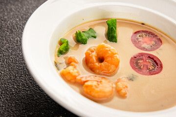 Tom kha soup shrimp, coconut milk, miso paste tasty seafood snack fresh delicious gourmet food background on the table rustic food top view copy space pescetarian diet