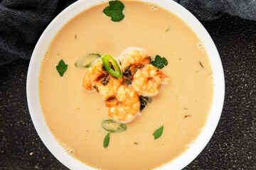 Tom kha soup shrimp, coconut milk, miso paste tasty seafood snack fresh delicious gourmet food background on the table rustic food top view copy space pescetarian diet