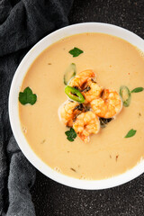 Tom kha soup shrimp, coconut milk, miso paste tasty seafood snack fresh delicious gourmet food background on the table rustic food top view copy space pescetarian diet