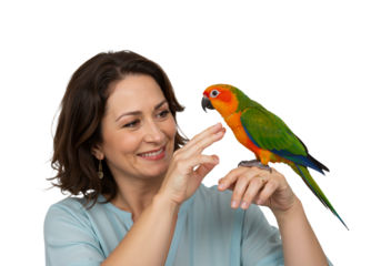 A beautiful middle-aged woman smiling as she interacts with her colorful pet Sun Conure parrot perched on her hand