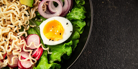 Vegetarian noodle bowl avocado, noodles, egg, vegetables tasty snack fresh delicious gourmet food background on the table rustic food top view copy space keto and paleo diet vegetarian food