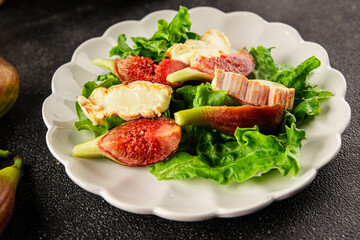 Salad figs, soft cheese, green leaf lettuce tasty snack fresh delicious gourmet food background on the table rustic food top view copy space keto and paleo diet vegetarian food