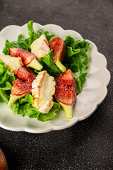 Salad figs, soft cheese, green leaf lettuce tasty snack fresh delicious gourmet food background on the table rustic food top view copy space keto and paleo diet vegetarian food