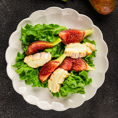 Salad figs, soft cheese, green leaf lettuce tasty snack fresh delicious gourmet food background on the table rustic food top view copy space keto and paleo diet vegetarian food