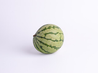 Whole fresh watermelon with green striped rind isolated on white background. Tropical summer fruit symbolizing freshness, sweetness, health, and natural organic food.

