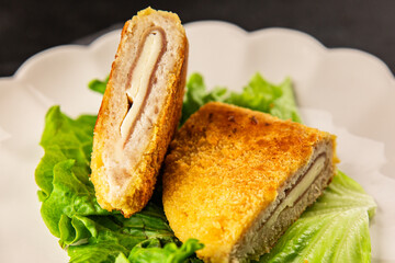 Cutlet cordon bleu meat chicken, cheese, ham second course french cuisine tasty snack fresh delicious gourmet food background on the table rustic food top view copy space