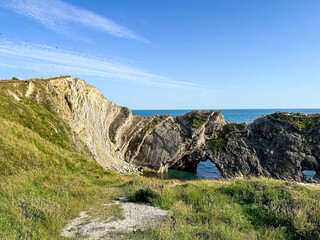 Jurassic coast view in Dorset, England, UK. Stair Hole near Lulworth Cove. Lulworth Cove cliffs view on a way to Durdle Door. The Jurassic Coast is a World Heritage Site on the English Channel coast