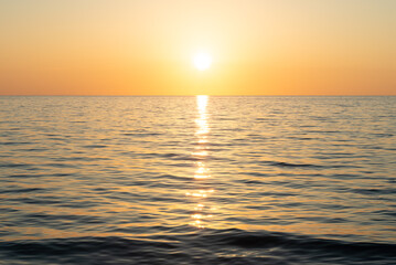 Fototapeta premium Seascape. Sunset on the Black Sea. Sunny path on the surface of the water.