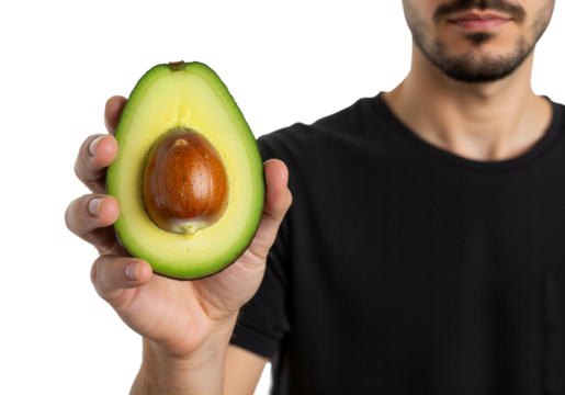Close up of a man holding a ripe avocado half with its pit visible, a healthy fruit and food concept