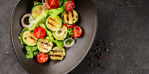 Salad grilled zucchini, tomato, lettuce tasty snack fresh delicious gourmet food background on the table rustic food top view copy space keto and paleo diet vegan and vegetarian food