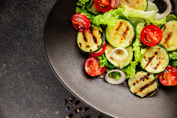 Salad grilled zucchini, tomato, lettuce tasty snack fresh delicious gourmet food background on the table rustic food top view copy space keto and paleo diet vegan and vegetarian food