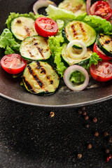 Salad grilled zucchini, tomato, lettuce tasty snack fresh delicious gourmet food background on the table rustic food top view copy space keto and paleo diet vegan and vegetarian food