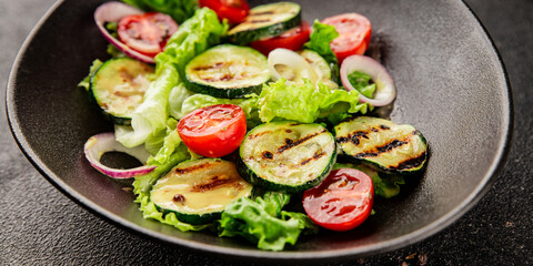 Salad grilled zucchini, tomato, lettuce tasty snack fresh delicious gourmet food background on the table rustic food top view copy space keto and paleo diet vegan and vegetarian food