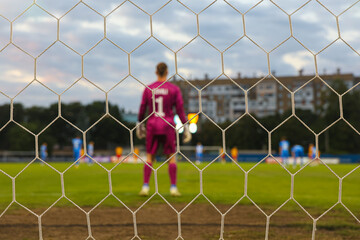 Blurred Football Goalkeeper Seen Through the Net &ndash; Artistic Sports Concept